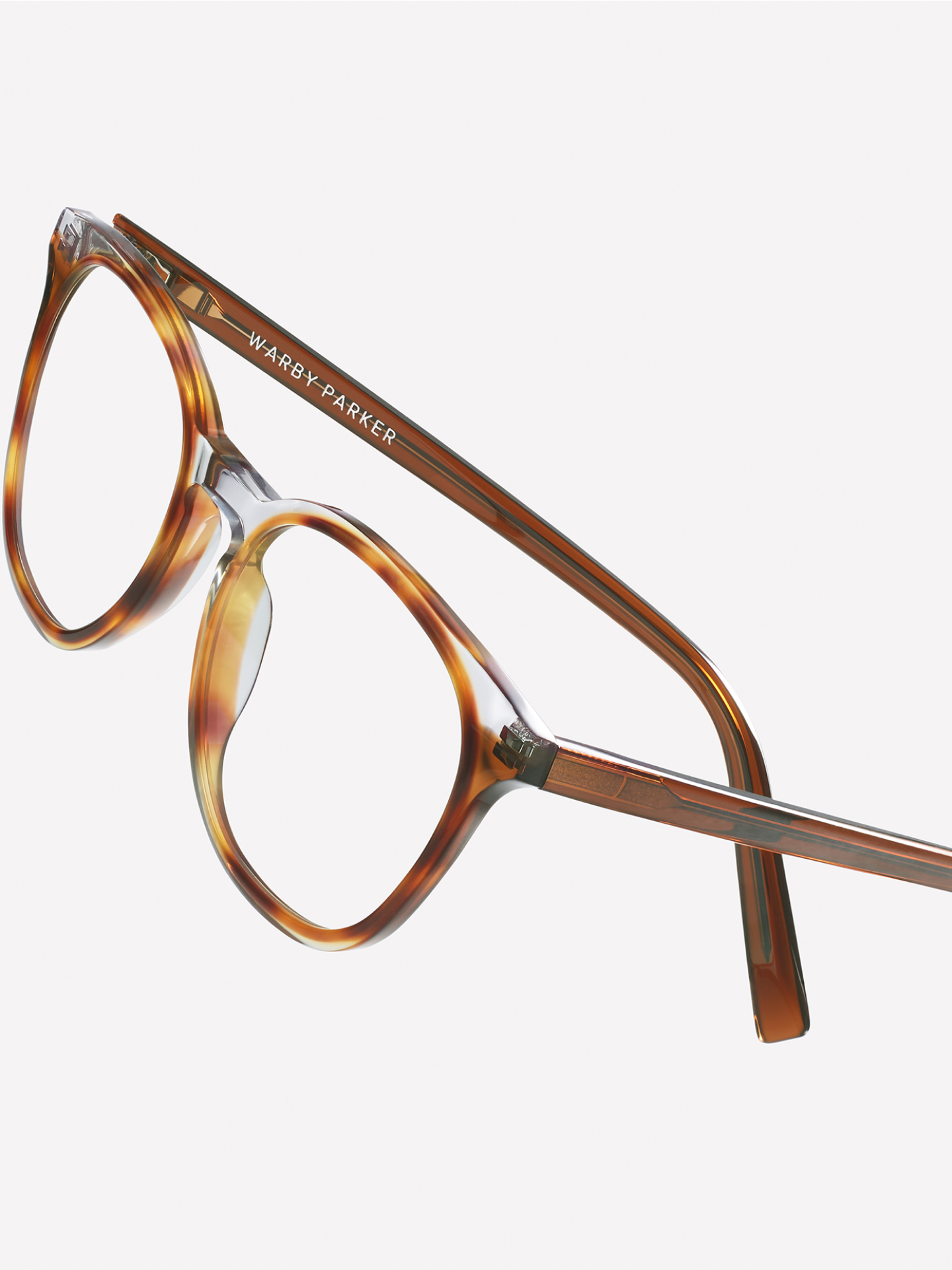 The Carlton frame in Nimbus Crystal with Cacao and Oak Barrel