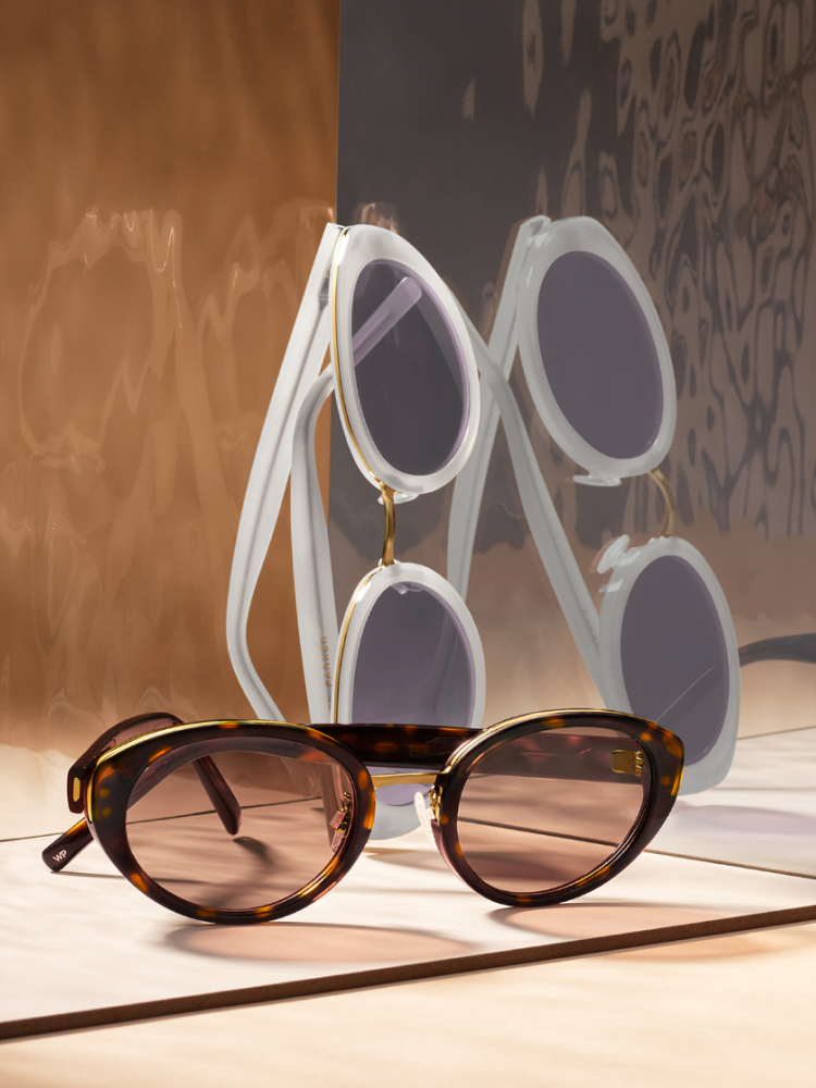 From top to bottom, the Kiki frame in Vapor with Polished Gold and the Kiki frame in Cognac Tortoise with Polished Gold