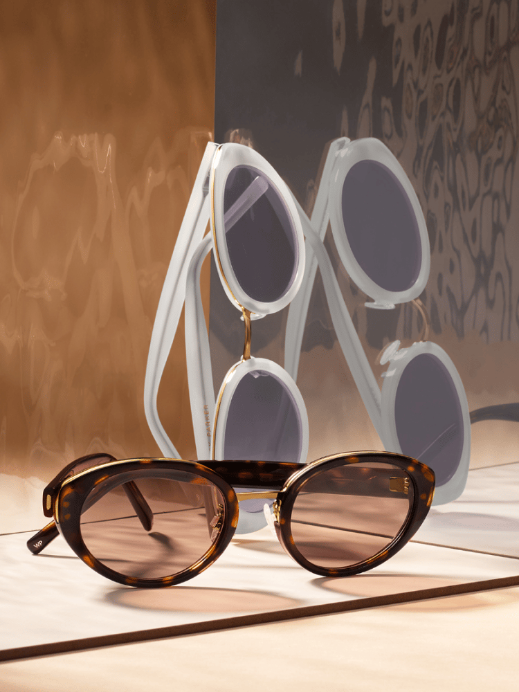 From top to bottom, the Kiki frame in Vapor with Polished Gold and the Kiki frame in Cognac Tortoise with Polished Gold