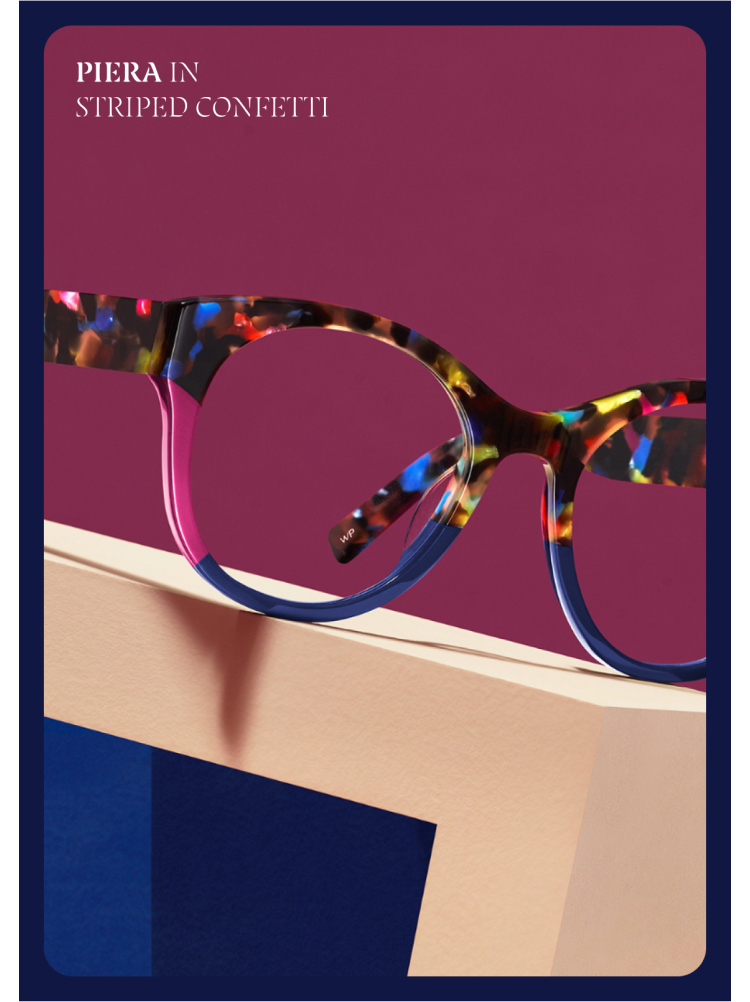 Vibrant eyeglasses with a playful "striped confetti" pattern, featuring a mix of colorful hues. They are set against a bold burgundy background, resting on a geometric pedestal with a cream and blue design. Text at the top left reads, "Piera in Striped Confetti." The eyeglasses exude a fun and whimsical style.