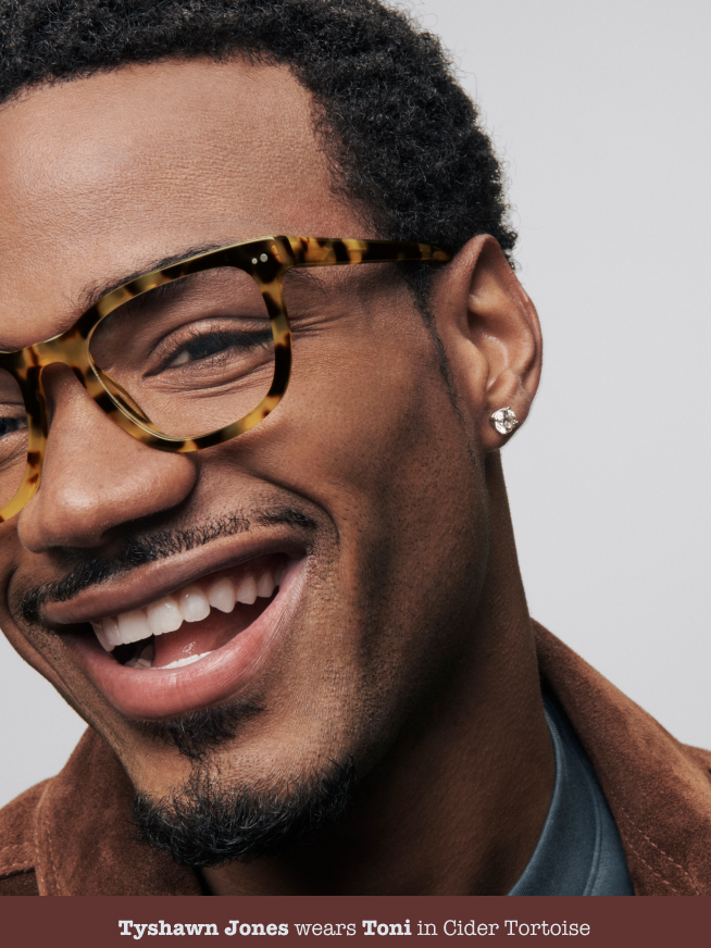 Man posing with glasses smiling.