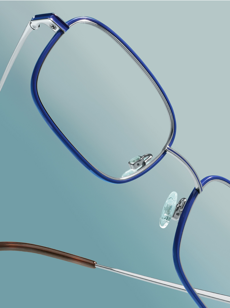 Close up on Talib in Blue Frames against a gradient blue background.