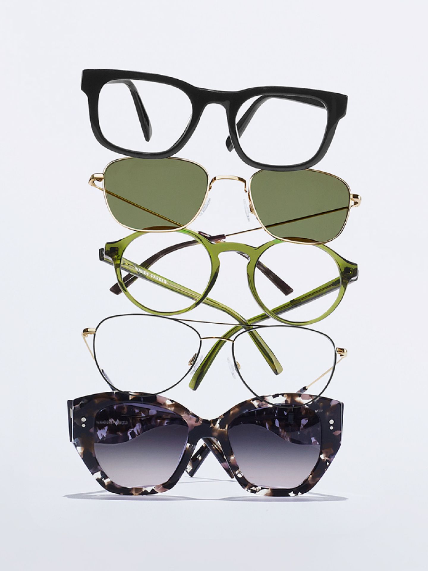 Stack of frames and sunglasses against a white background.