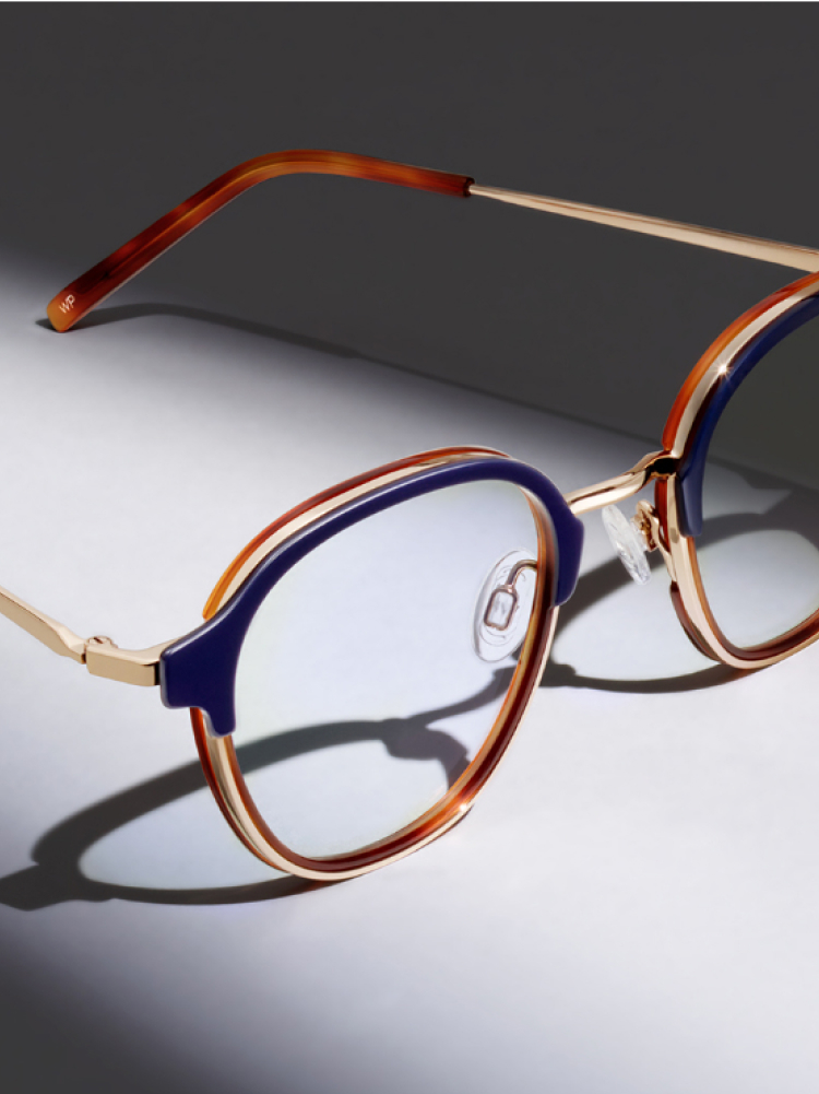 Close up on glasses against a gray background.