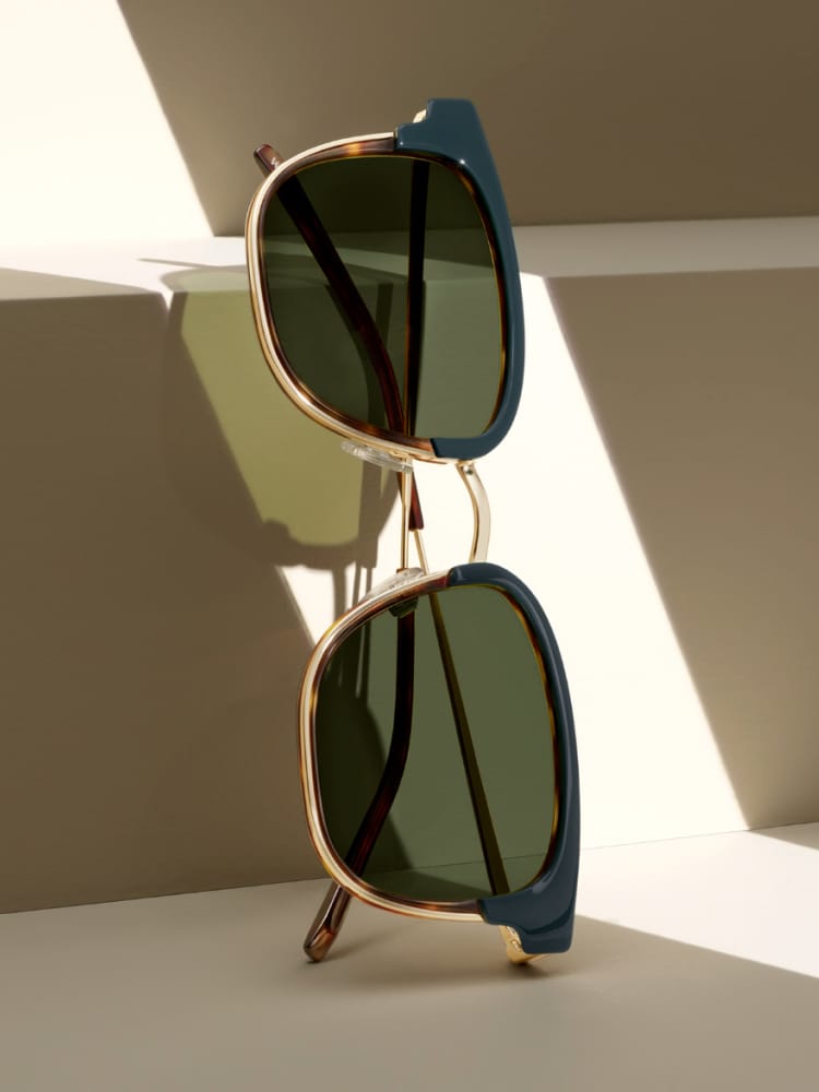 Close up on sunglasses leaning a geometric piece.