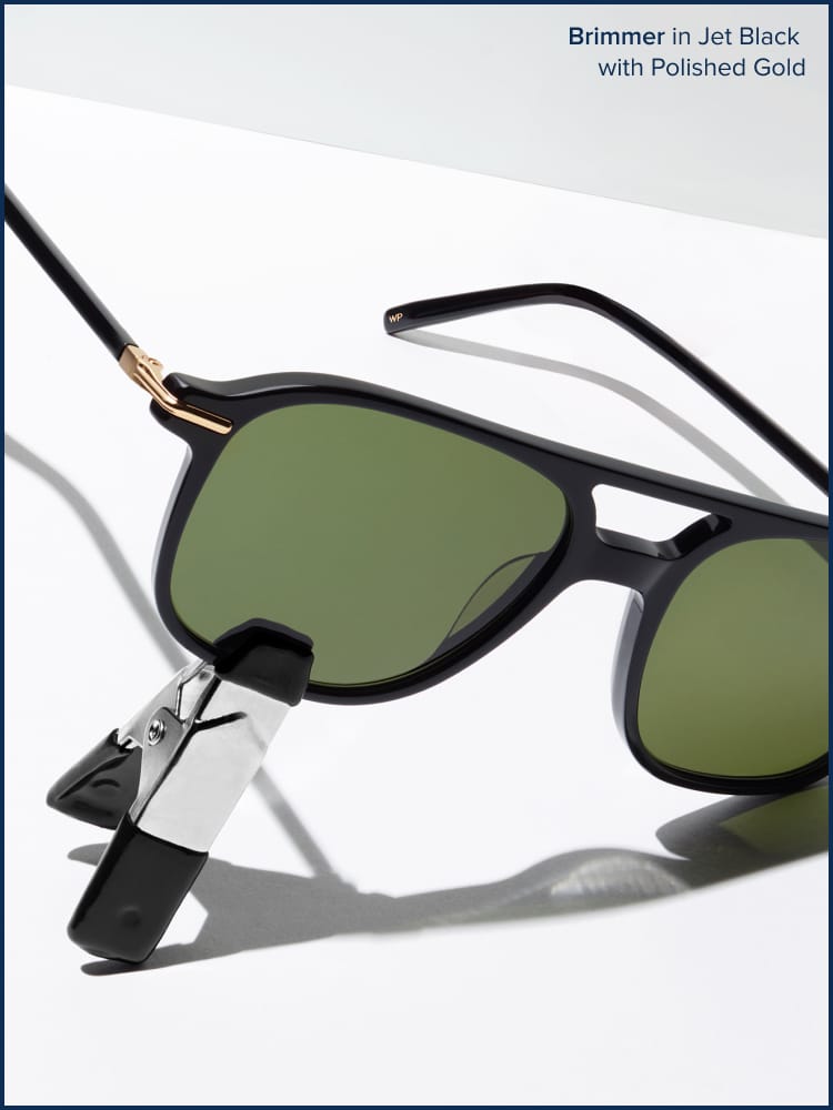 Sunglasses holded by a clip on a white background.
