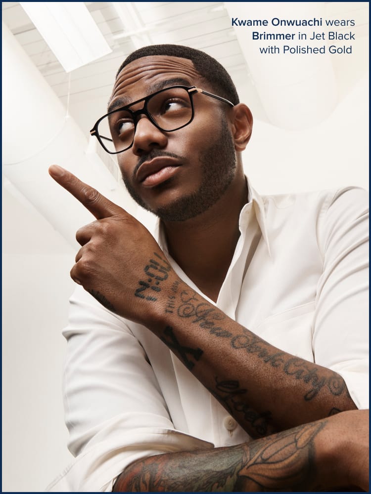 Person pointing a finger up wearing glasses and looking up.
