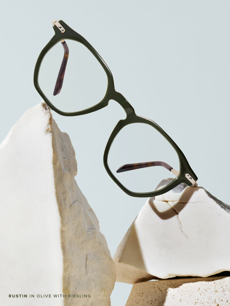 Square eyeglasses displayed on pieces of terra clay