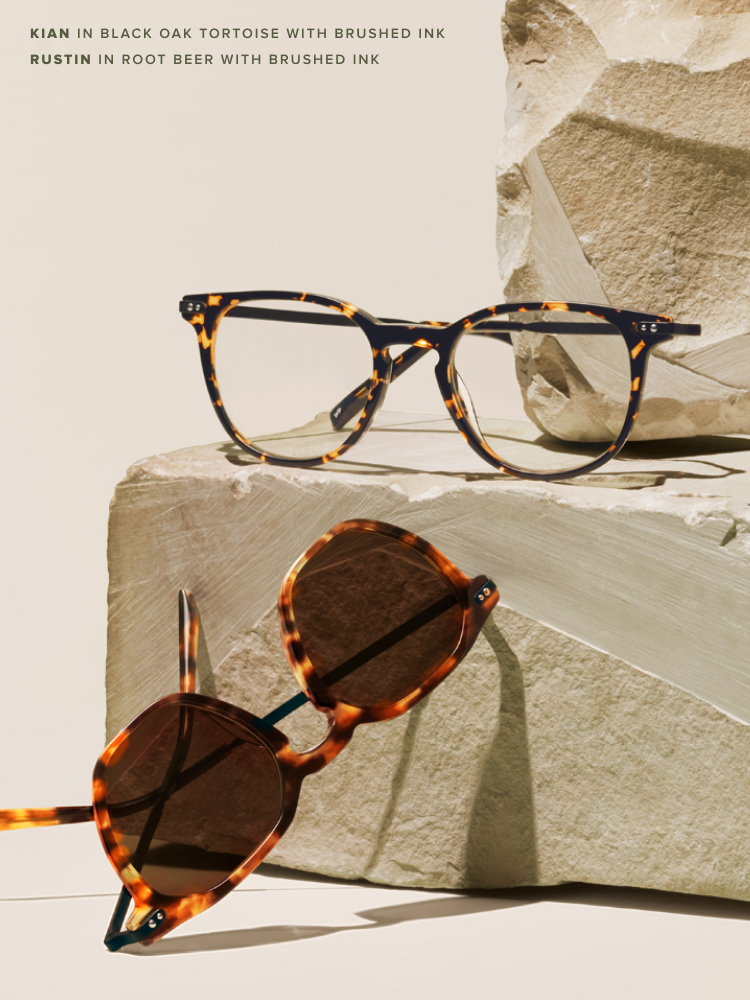 Tortoise frame eyeglasses and sunglasses leaned on pieces of terra clay