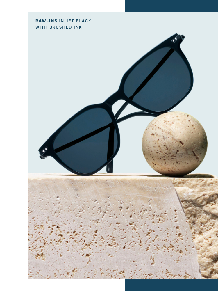 Black square sunglasses balanced on a terra clay