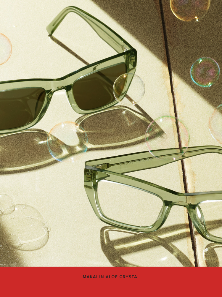Two pairs of the Makai frame in Aloe Crystal rest on a picnic table.