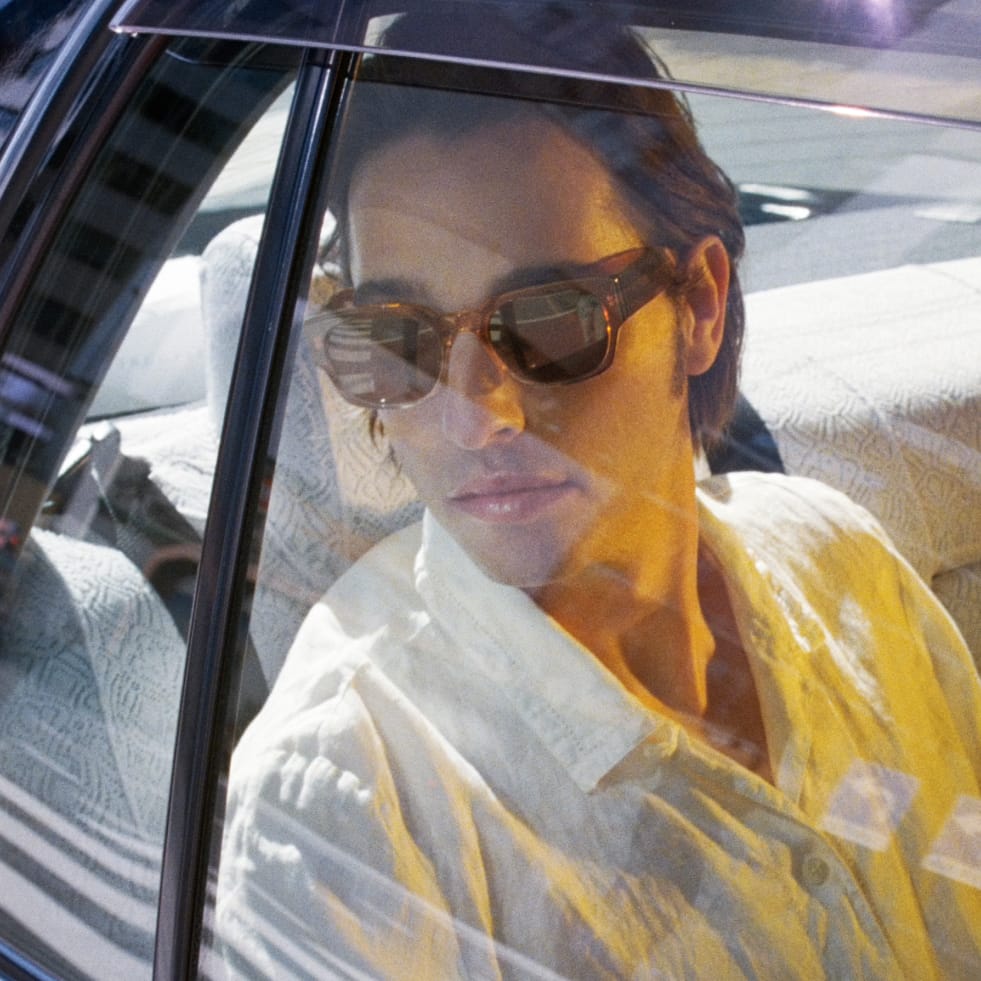 Model wears the Domingo frame in Cinnamon Crystal Fade