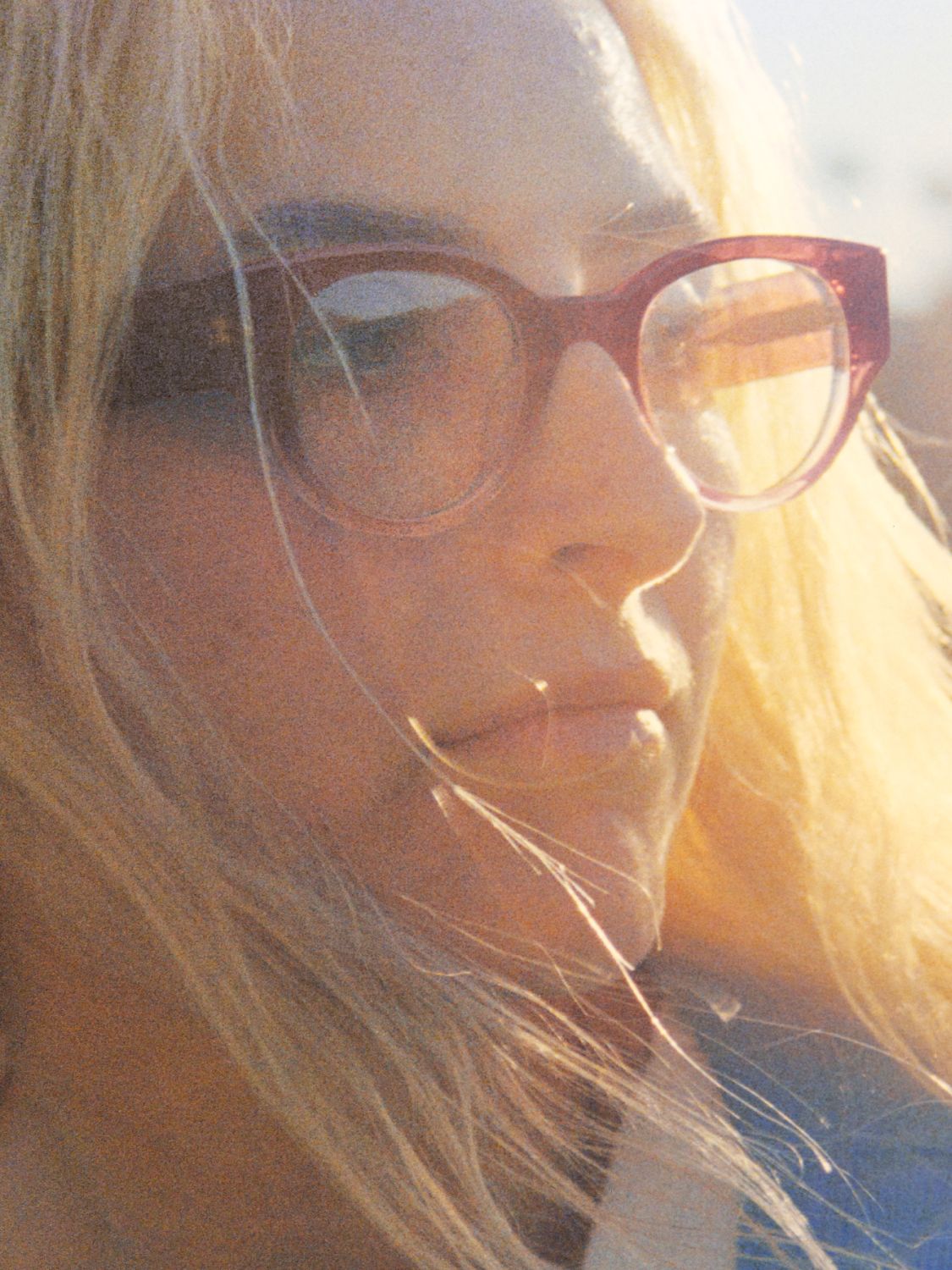 Model wears the Leti frame in Elderberry Crystal Fade