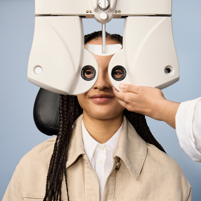 Girl sitting with Eye exam machine