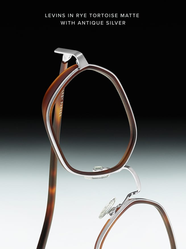 Levins eyeglasses in Rye Tortoise Matte with Antique Silver, featuring a geometric frame design combining tortoise-patterned acetate and silver metal, with clear nose pads for comfort, displayed against a gradient background.