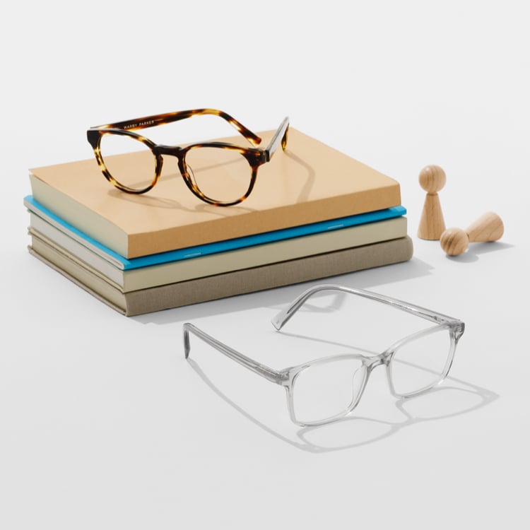 Eyeglasses stacked on books