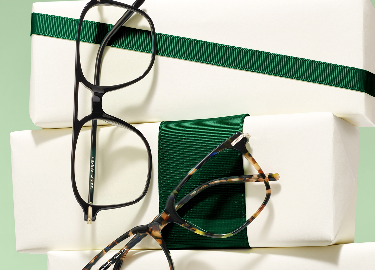 Two frames leaning on blocks with a green ribbon