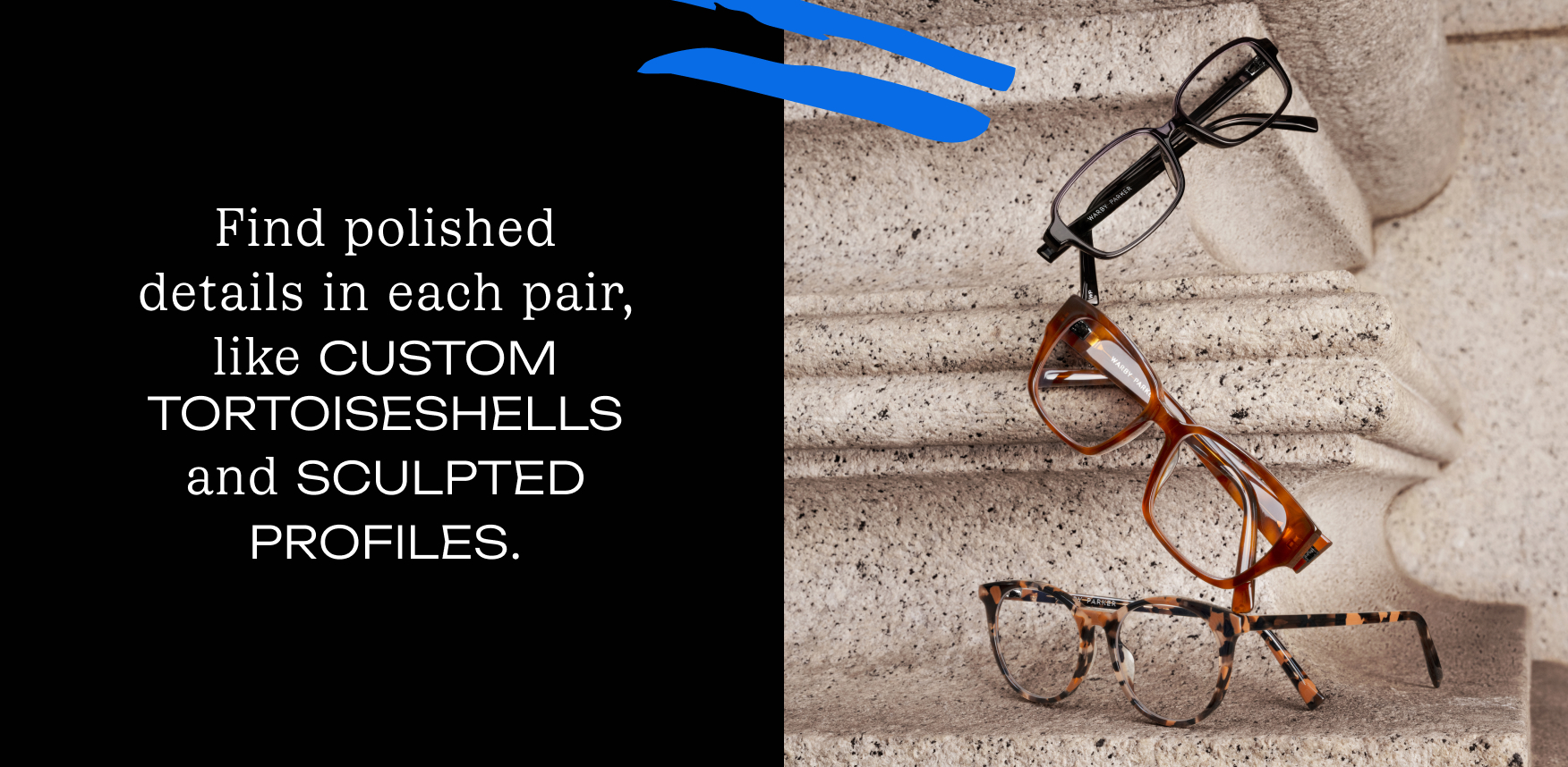 Three pairs of glasses stacked on a textured surface. The glasses have different frame styles and colors.