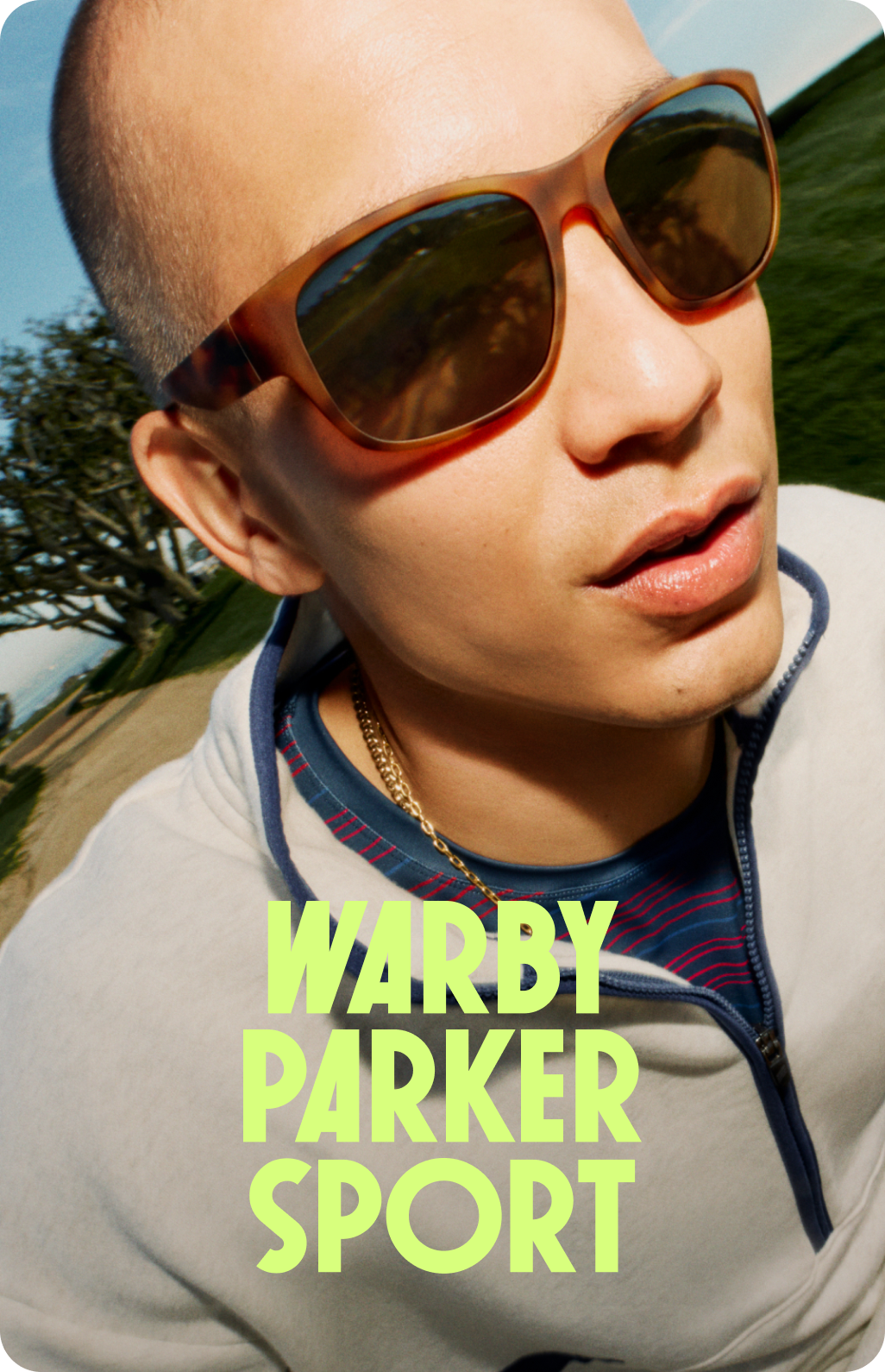 A man gives a piggyback ride to a woman, both wearing Warby Parker sunglasses in a scenic outdoor setting.