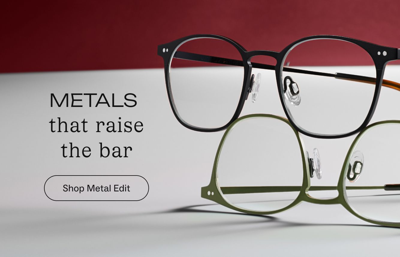 Black metal eyeglasses on a textured brown background with text "METALS that raise the bar."