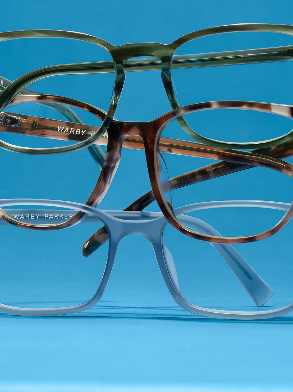 A close-up shot showcases three pairs of glasses stacked on top of each other.