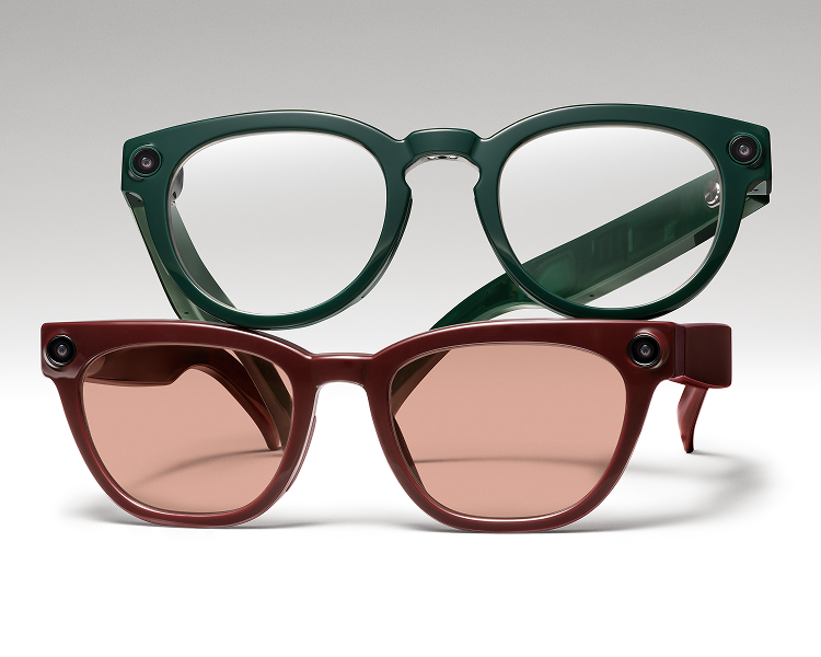 Two pairs of glasses, one with clear lenses and a green frame, the other with pink lenses and a red frame.