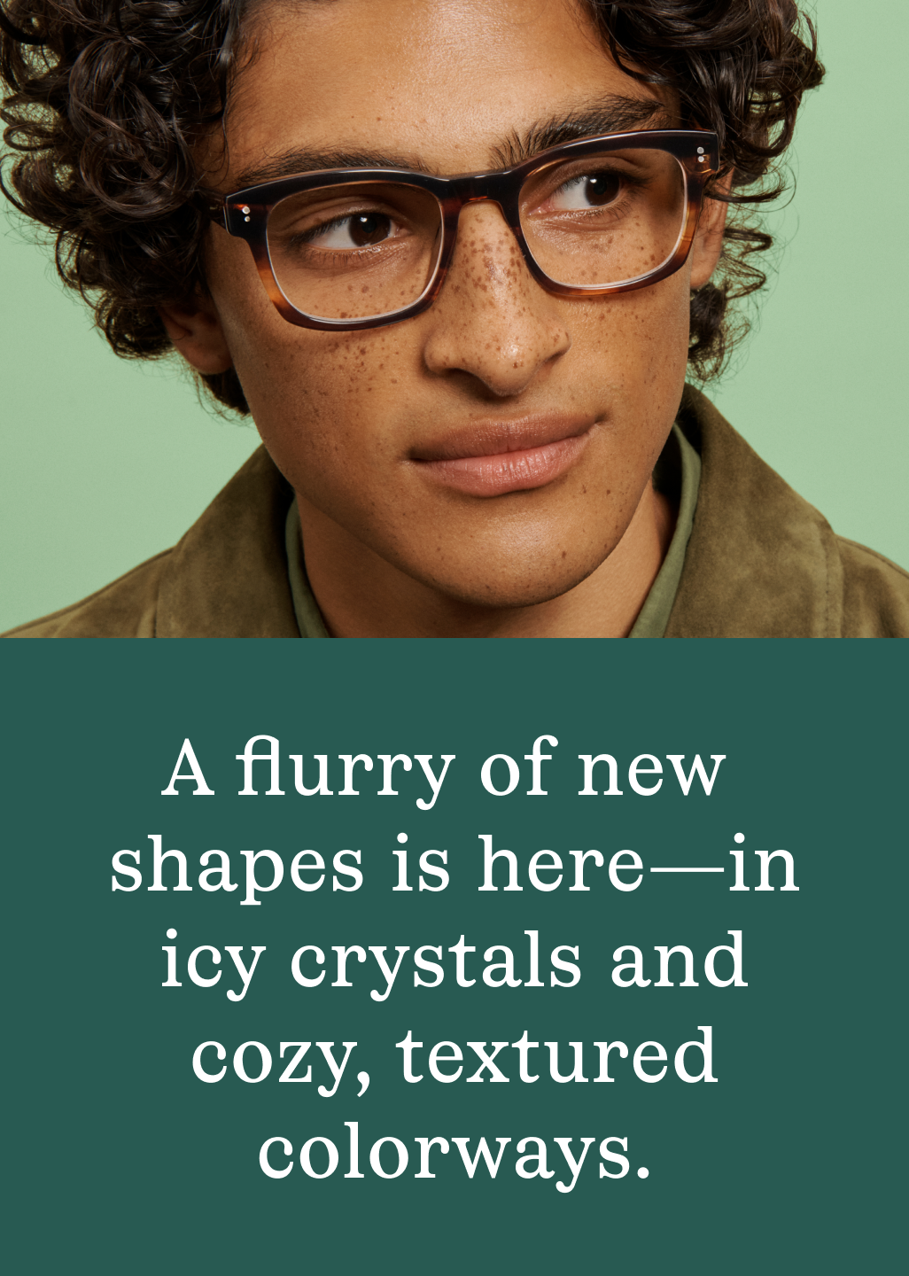 Man in green jacket wearing squared tortoise glasses