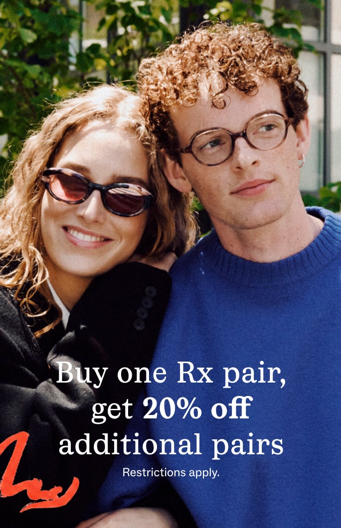 A couple wearing glasses smiles at the camera, promoting a "Buy one Rx pair, get 20% off" sale.