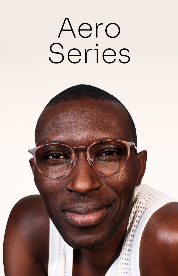 A man with glasses and a white tank top smiles in the Aero Series.