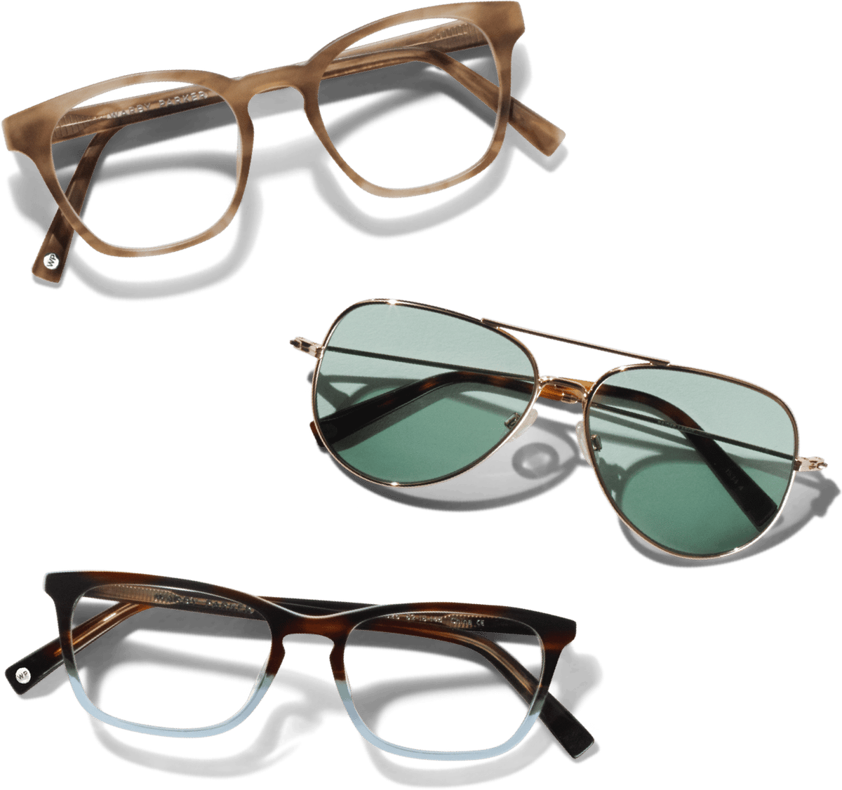 Three pairs of eyewear: a round brown eyeglass frame, green-lensed aviator sunglasses, and a brown-to-clear gradient eyeglass frame.