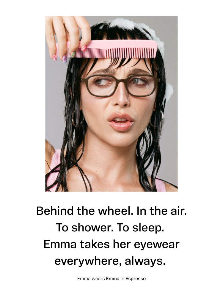 A person with wet hair and glasses, holding a pink comb. Text: "Behind the wheel. In the air. To shower. To sleep. Emma takes her eyewear everywhere, always. Emma wears Emma in Espresso."