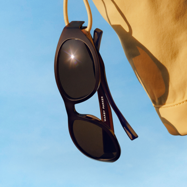 Zoomed in photo of Warby Parker sun glass with a sky background
