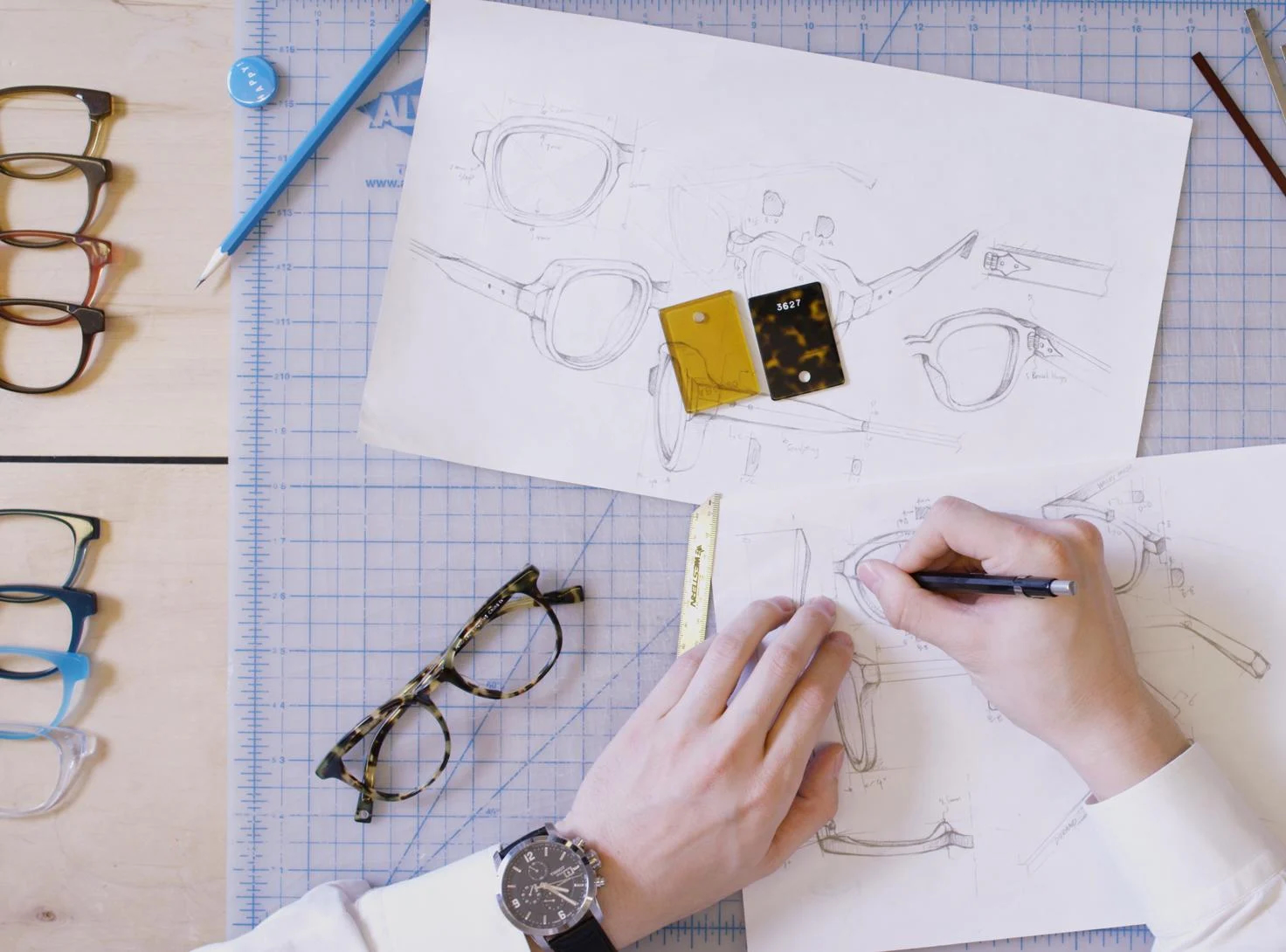 Person sketching and designing Warby Parker glasses