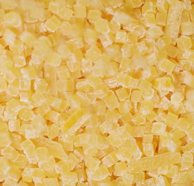 Hundreds of square yellow acetate pieces in a pile.