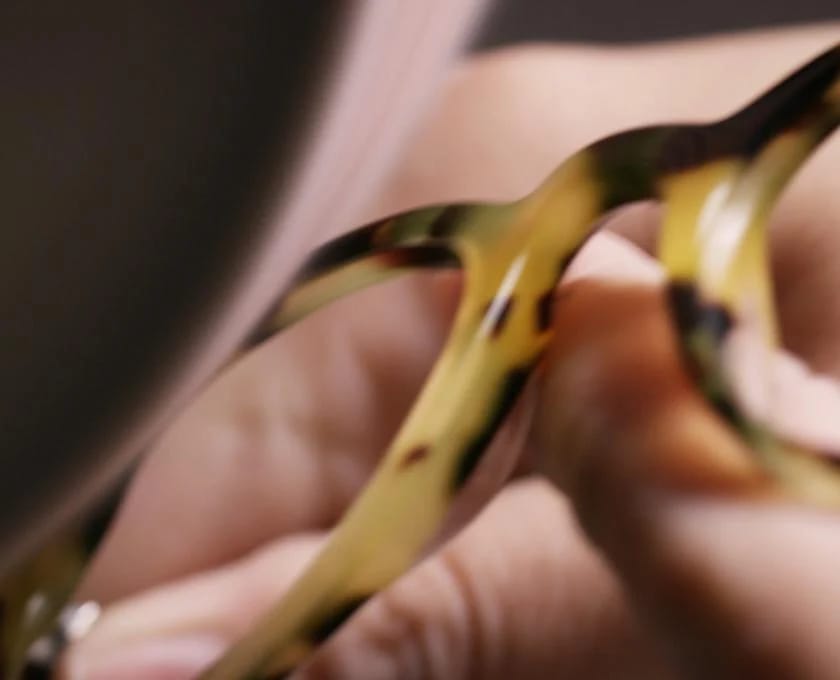 Yellow and black acetate frame face after being polished for an extra-glossy finish.