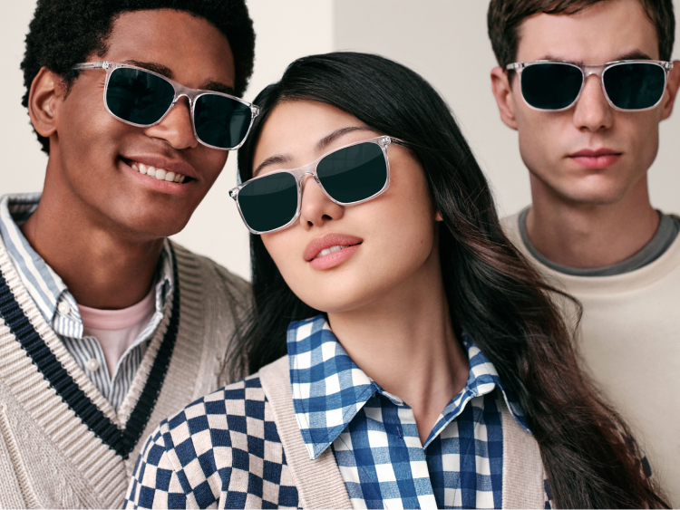 Group posing together with glasses looking at the camera
