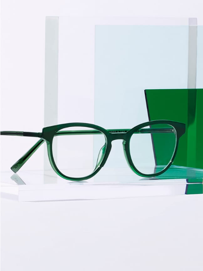 Green frame resting on top of a crystal.