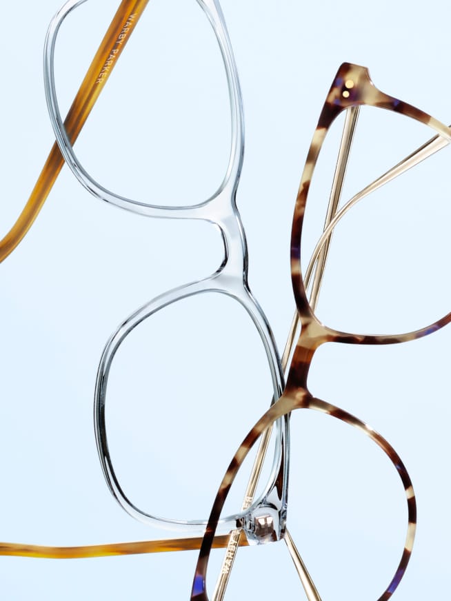 Two pairs of eyeglasses, one with clear frames and the other with tortoiseshell frames, displayed against a light blue background.