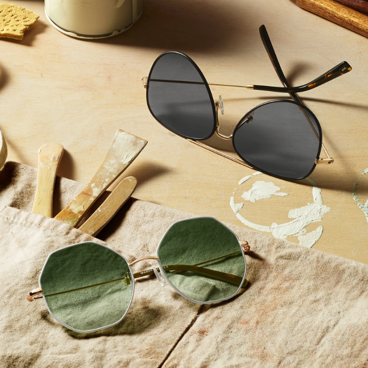 Sunglasses on top of paint tools.