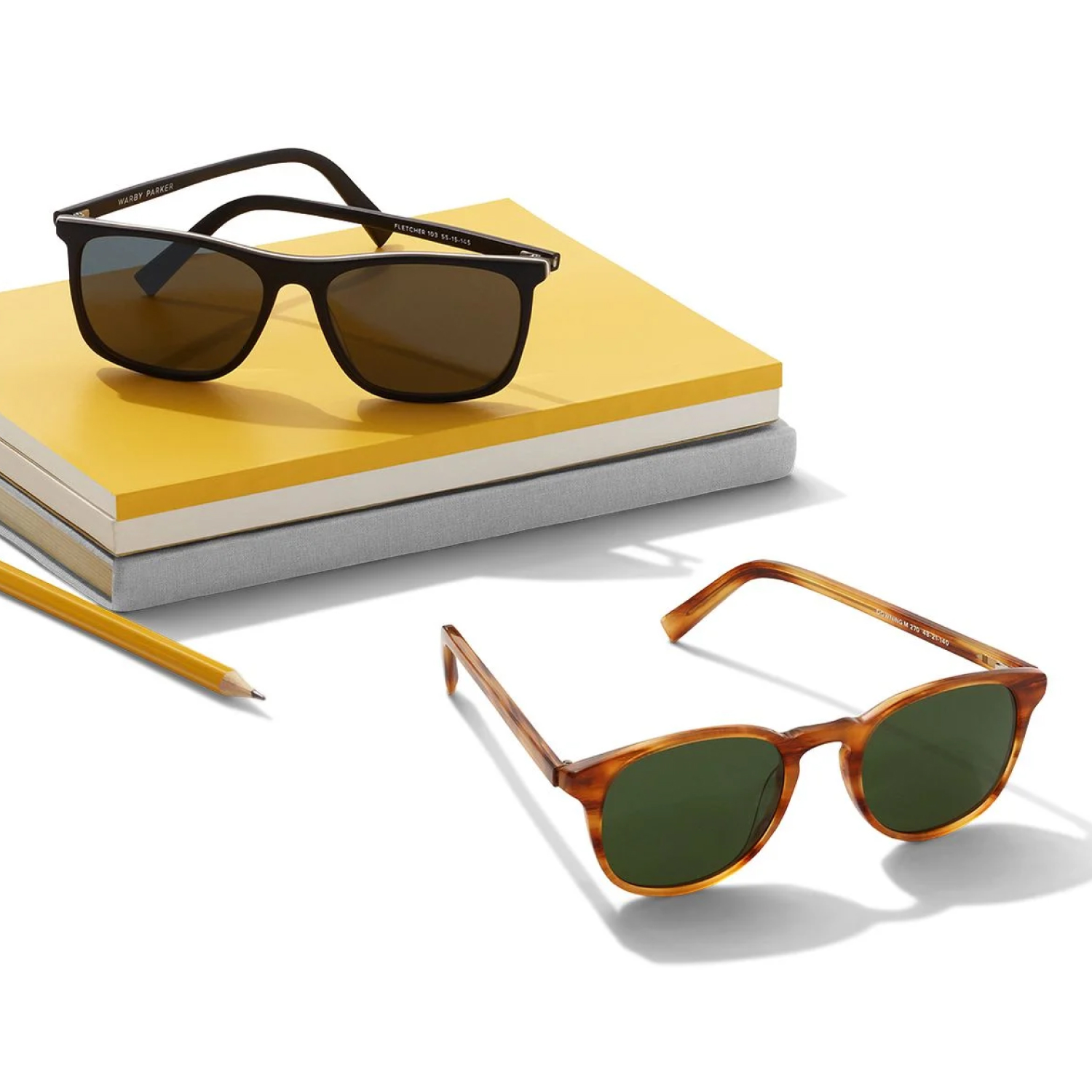 Sunglasses with school supplies in a white background.