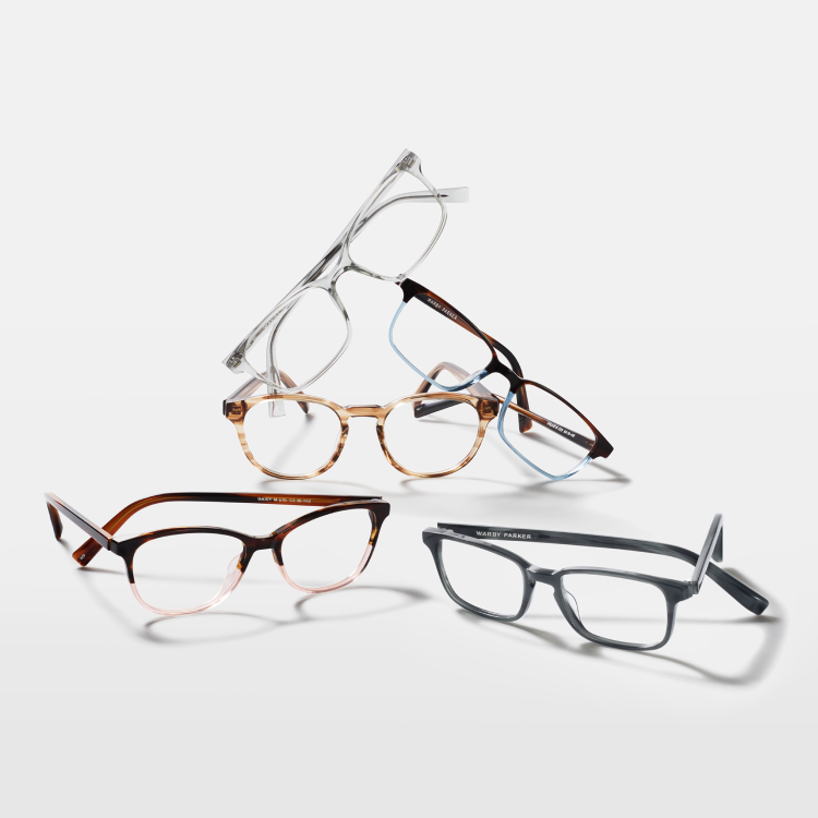Five Warby Parker eyeglasses in different styles on a white background