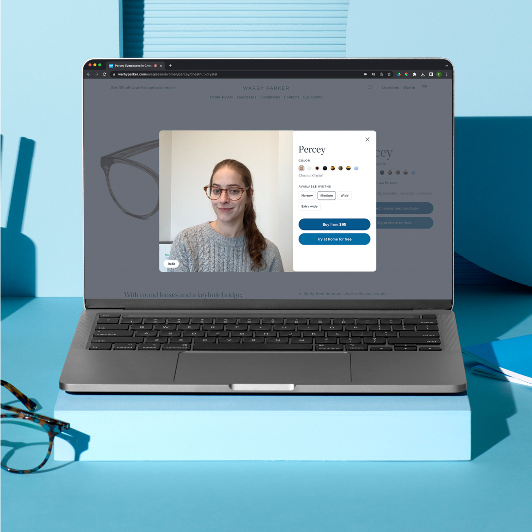 Customer virtually trying on the Percey eyeglass from her laptop where she can choose different colors and widths