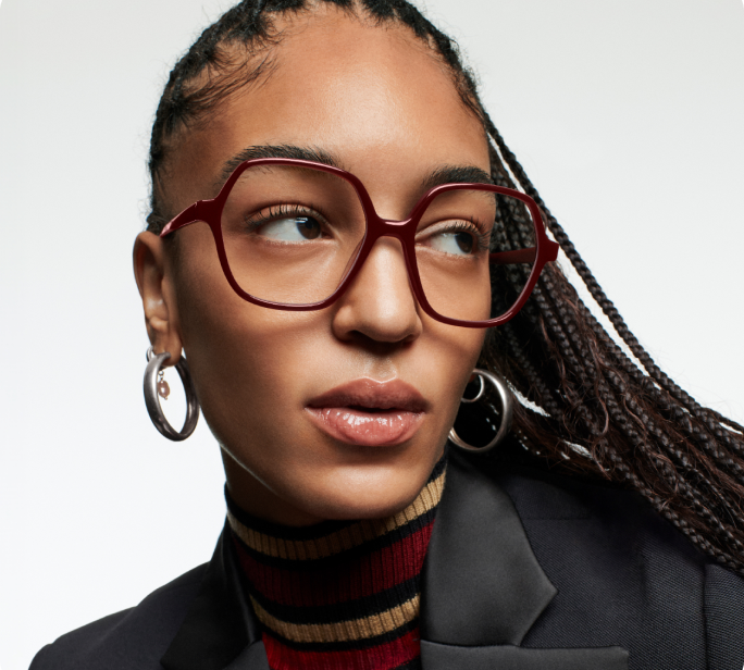 Model wears the Tatiana frame in Amarena.