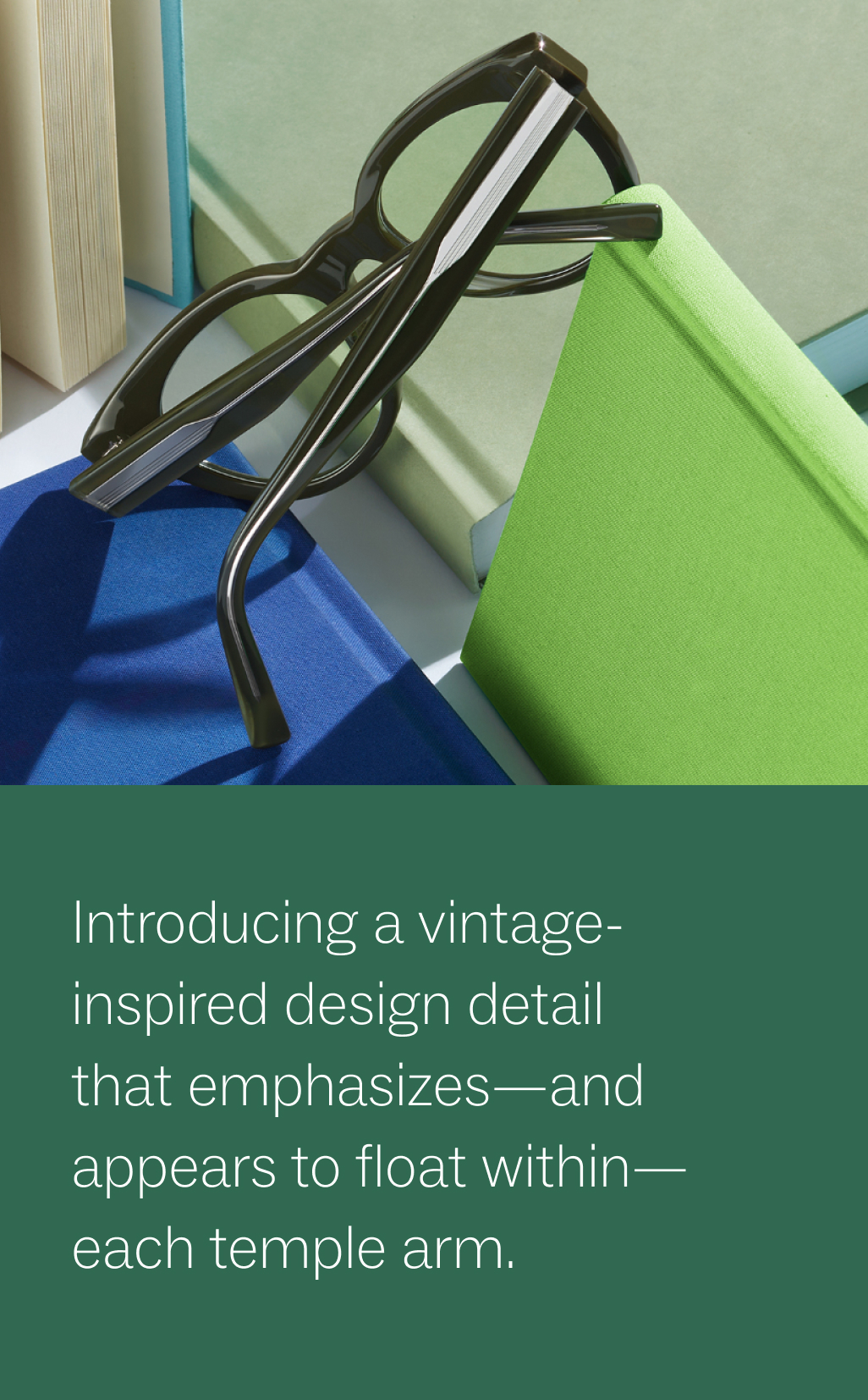 A pair of black glasses is placed on top of several books with green and blue covers. Below, there's a caption in white text on a green background that reads: "Introducing a vintage-inspired design detail that emphasizes—and appears to float within—each temple arm."