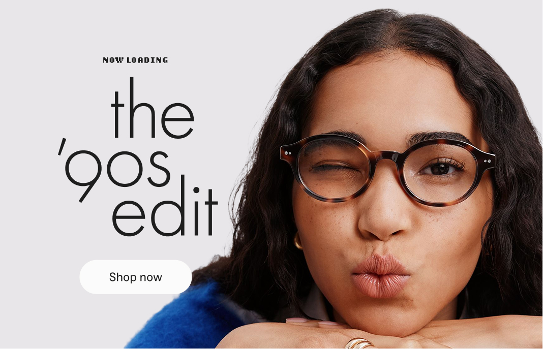 A woman winks while wearing tortoise-shell glasses, promoting the '90s Edit collection.
