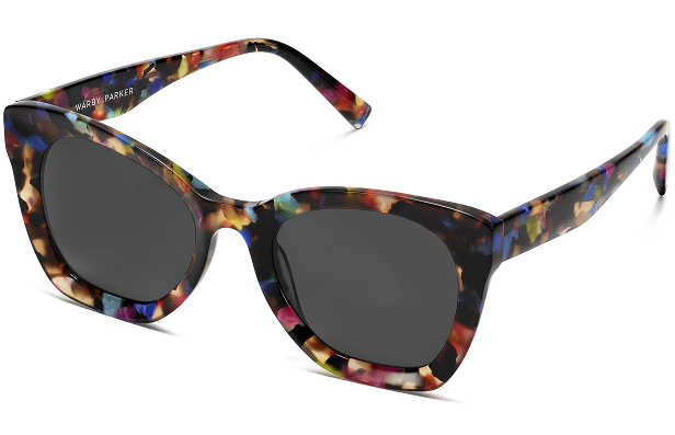 Colorful floral patterned sunglasses with dark lenses and "Warby Parker" branding on frame.