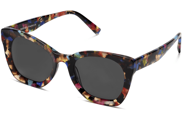 Colorful floral patterned sunglasses with dark lenses and "Warby Parker" branding on frame.