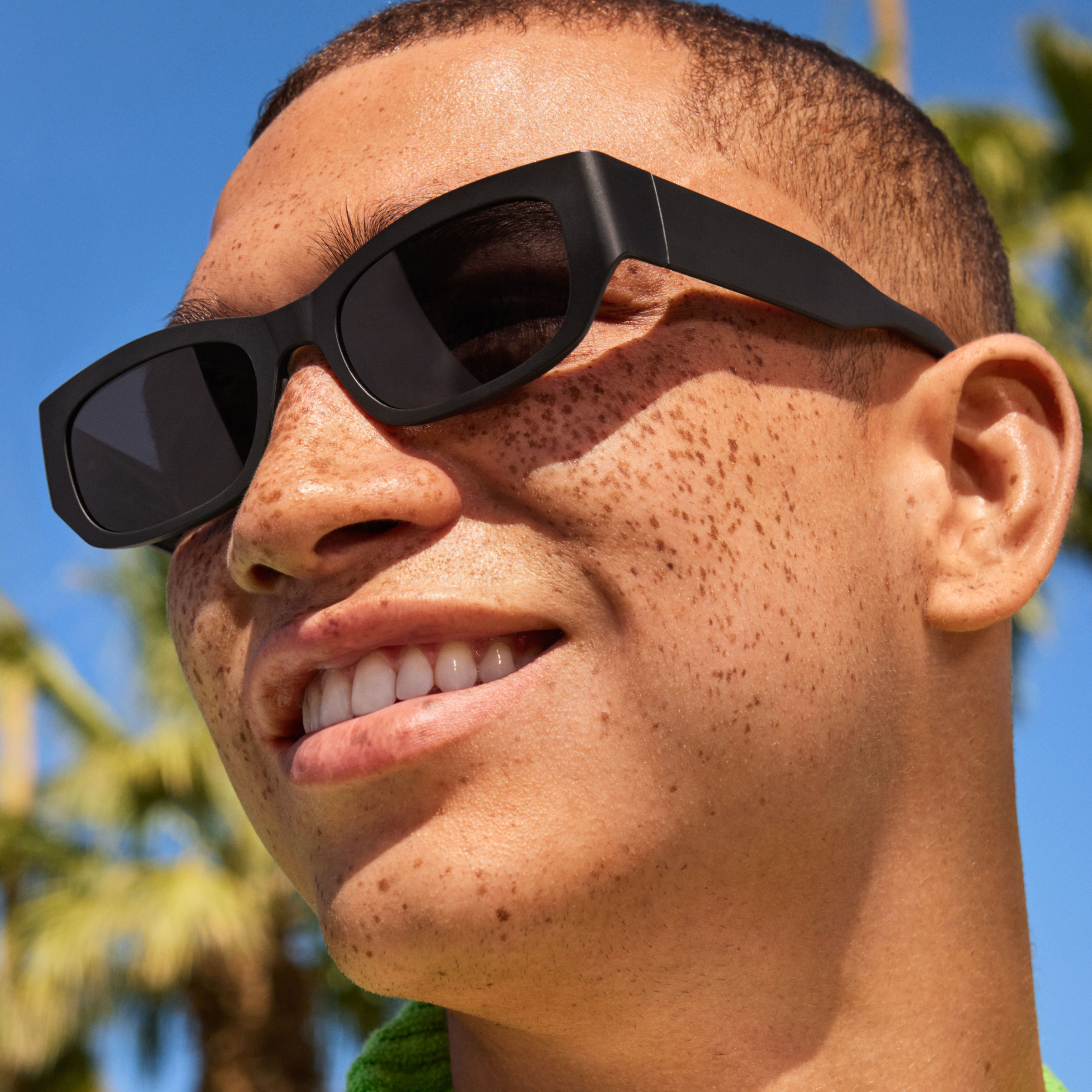 Two eyeglasses & one sunglass with green background