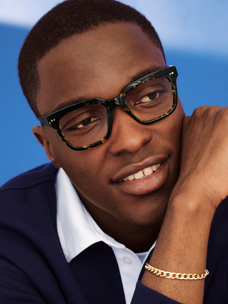 person wearing tortoiseshell square glasses