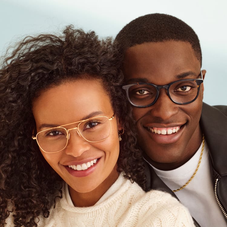 People posing with glasses.
